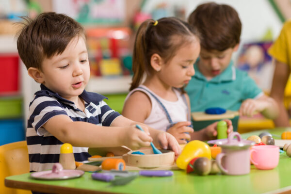 Childs are playing with play clay in classroom